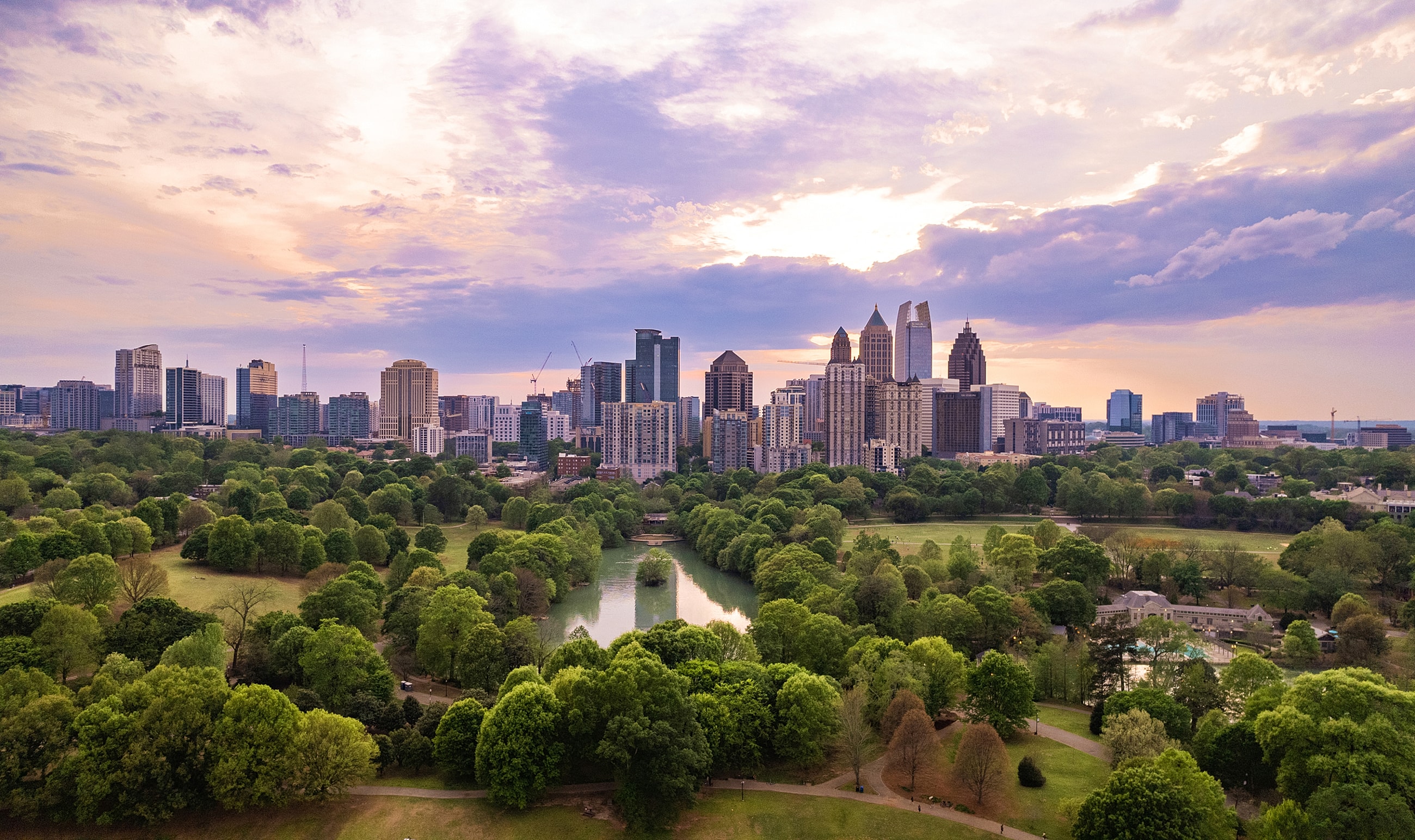 City skyline over lush green parkland.